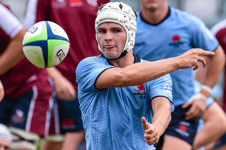 Harrison Dene fires a ball out the backline