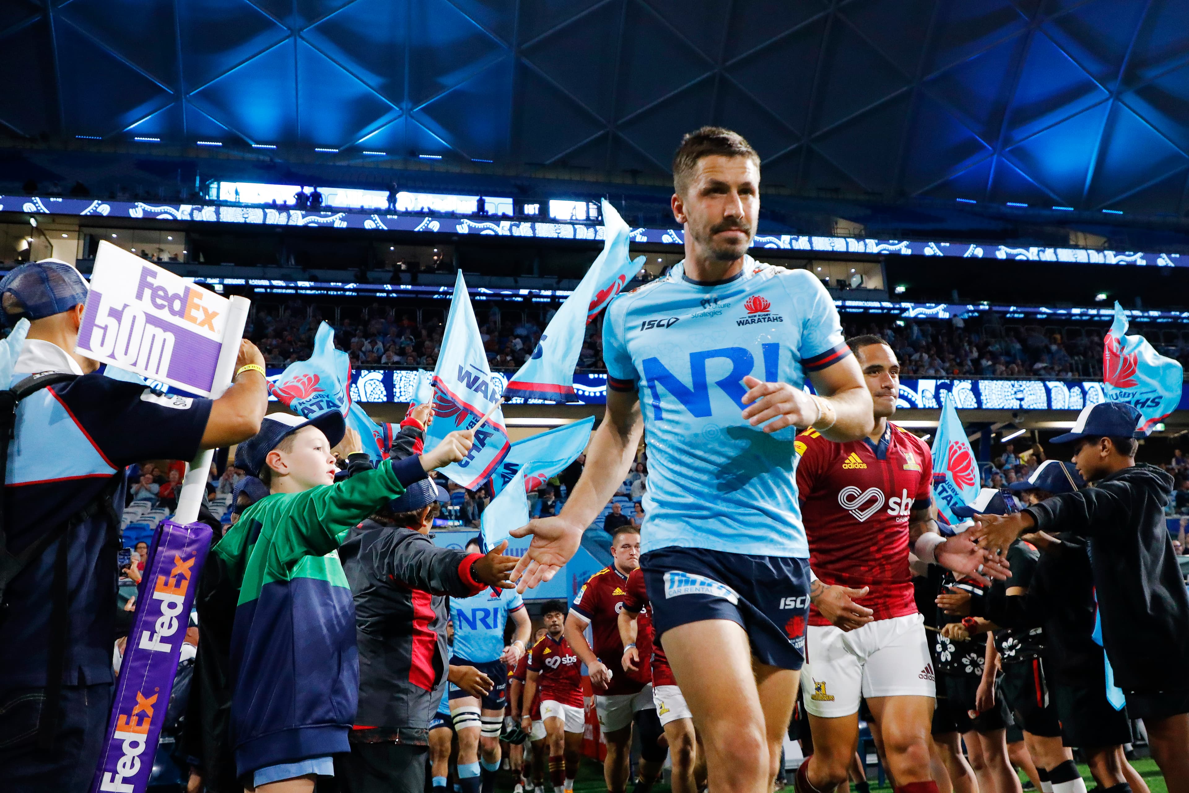 Jake Gordon leads the Waratahs out onto Allianz Stadium against the Highlanders